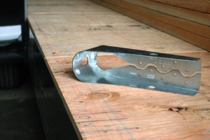 Two more rods will be added that will, together with two of these neat metal brackets, hold our door in place.